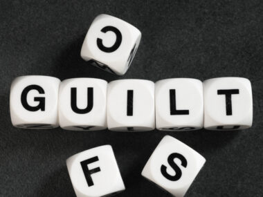 guilt | Angioedema News | Stock photo of scrabble dice that spell out 