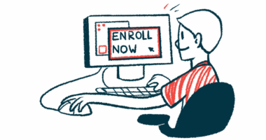 A person sits at a computer with the screen reading 