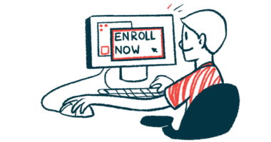 A person sits at a computer with the screen reading 