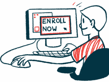 A person sits at a computer with the screen reading 