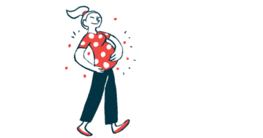A pregnant woman hugs her belly during a walk.