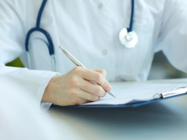 doctor writing in a chart