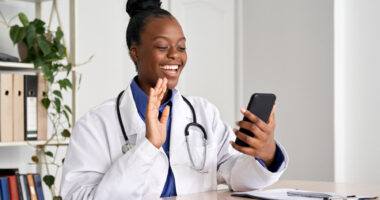 A female doctor greeting a patient on a cell phone call