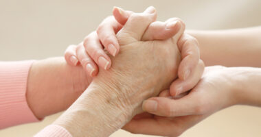 close-up of two people holding hands to illustrate helping hands