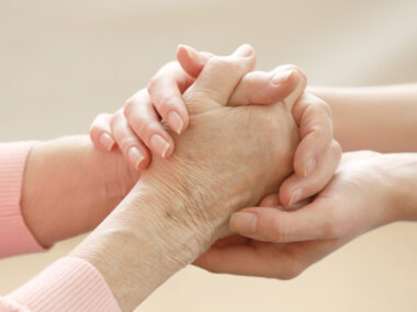 close-up of two people holding hands to illustrate helping hands