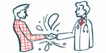 Two people are shown shaking hands.